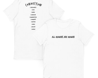 May include: Two white t-shirts with black text. One says "ALL HUMANS ARE HUMAN". The other has "CONNECTION" at the top, followed by words like "CONSCIOUSNESS", "CHANGE", and "COURAGE".