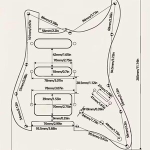 May include: A black and white technical line drawing of an electric guitar pickguard with multiple cutouts for pickups and controls. The diagram includes precise measurements in both millimeters and inches, detailing the spacing and dimensions.