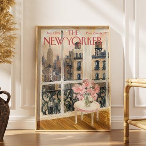 May include: A framed print of The New Yorker magazine cover dated July 1, 1974, priced at 25 cents. The artwork depicts a city view through a window with a small round table holding a vase of pink flowers in the foreground and buildings outside.