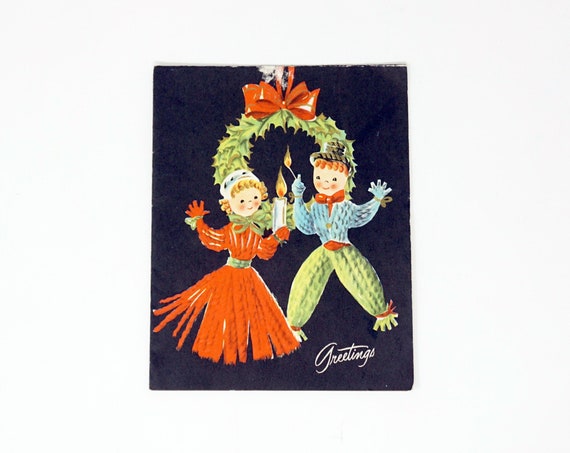 Vintage Christmas Card 50s Holiday Illustration Carolers Dolls Yule Candle Green Wreath Red Ribbon Black Kitsch Mid Century Greeting of Joy