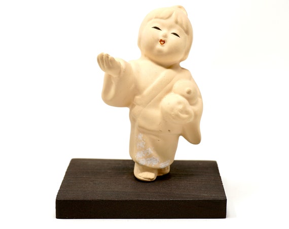 Vintage Geisha Girl Japan Hakata Bisque Doll on Stand 60s Souvenir Japanese Girl Figurine Holds Fruit Offering Symbol Pottery on Wood Stand