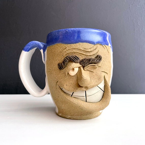 Vintage Ugly Face Mug Pottery Handmade Winking Coffee Cup White Glaze Blue Rim Unglazed Expressive Man Face Cup Smile Big Brows Signed Julie