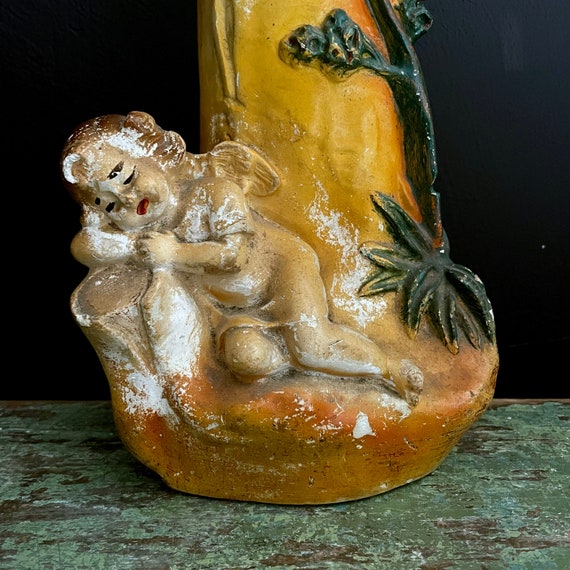 Vintage Chalkware Vase Cherub Sleeping on the Base Golden Tone Painted Chalk Ware Vessel Asymmetrical Winged Angel Baby Figure Green Foliage