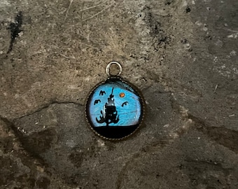 Vintage Pendant Morpho Reverse Painted Butterfly Wing Necklace Tiny Pine Tree Sunset Scene in Black On Iridescent Purple Blue Orange Wing