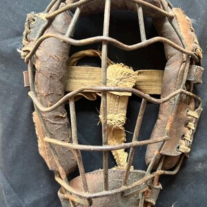 Early 1900’s baseball mask.      Steel wired cage and leathered line padding.