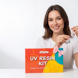 May include: A woman holds two resin pendants next to a box labeled "UV RESIN KIT". The box is red, orange, yellow, and teal, with a pink bow. The pendants are round, with floral and colorful inclusions.