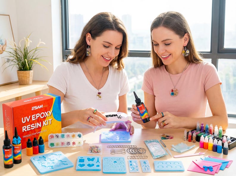 May include: Two women are seated at a table with a UV epoxy resin kit and various crafting supplies. The kit includes resin bottles, molds, and colorful pigments. The box reads "UV Epoxy Resin Kit".