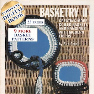 May include: The cover of a book titled "Basketry II" displays two coiled basket designs in blue, black, white, and red. Text on the cover includes "Creating More Coiled Baskets and Hangings with Modern Fibers" and "9 More Basket Patterns".