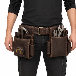 May include: A dark brown leather tool belt featuring two large pouches with multiple compartments. The belt is equipped with a metal buckle and holds various tools, including a hammer, a tape measure, pliers, and an adjustable wrench.