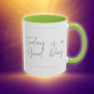May include: A white ceramic mug with a bright lime green interior and handle. The exterior features the text Today is a Good Day written in a cursive script font, centered between two thin horizontal lines on the front of the mug.