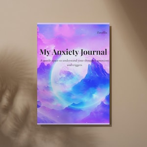 Op de afbeelding: Een dagboek getiteld "My Anxiety Journal" met een kleurrijke omslag met een hemels landschap in tinten paars, blauw en wit. De tekst op de omslag luidt "My Anxiety Journal" en "A gentle space to understand your thoughts, emotions and triggers."