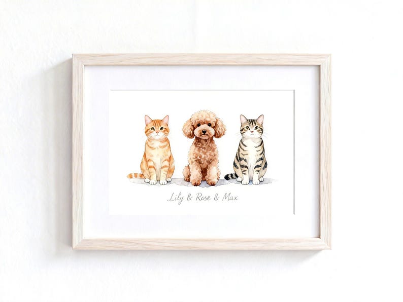 May include: A framed watercolor print featuring an orange tabby cat, a brown curly-haired poodle, and a grey tabby cat sitting side-by-side. Below the animals, the text Lily & Rose & Max is printed in a simple, elegant, light grey script font.