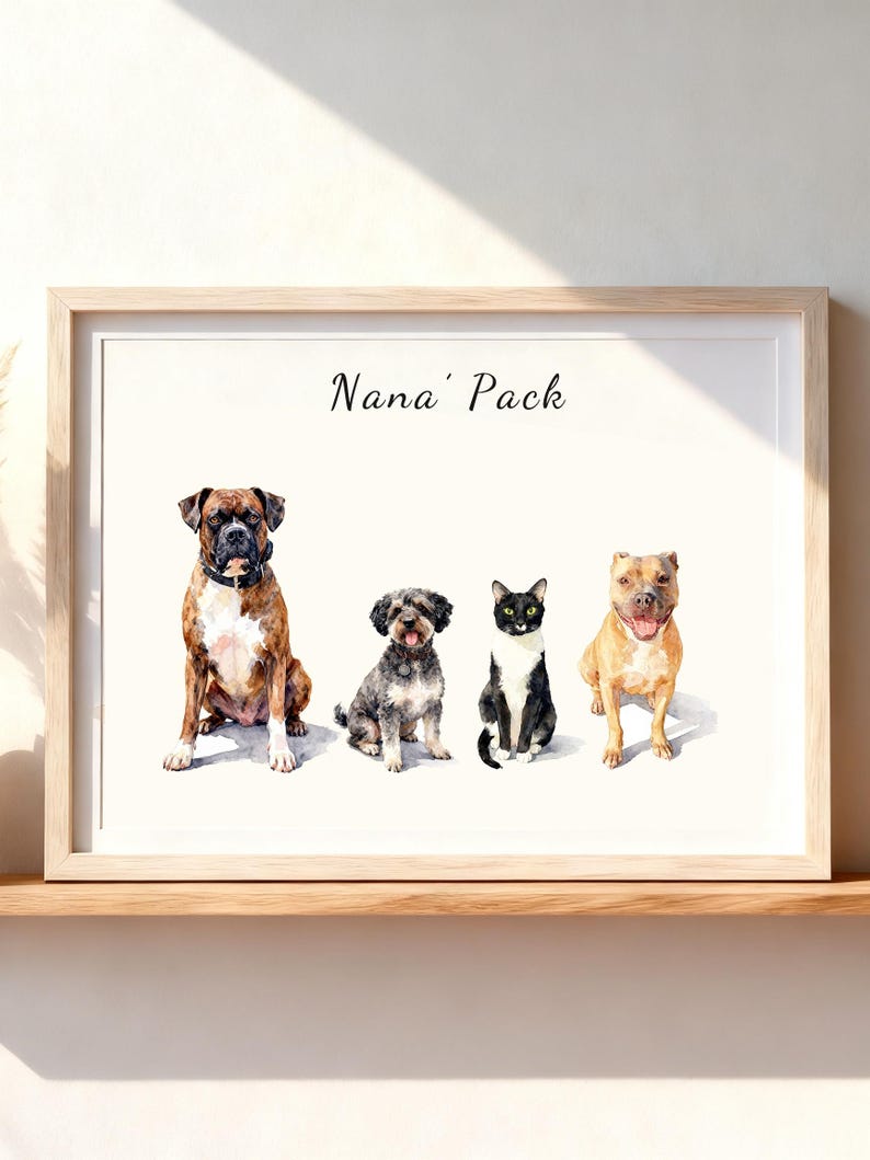 May include: A framed watercolor print featuring the text Nana' Pack above four animals: a brown and white Boxer dog, a small gray and black curly-haired dog, a black and white cat, and a tan pit bull-type dog, all sitting on a white background.