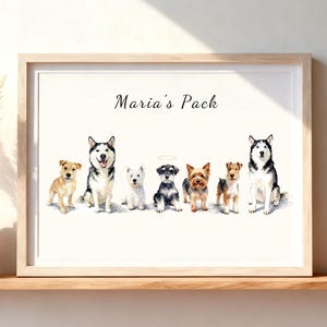 May include: A framed watercolor print featuring seven dogs of various breeds standing in a row. Above the dogs, the text Maria's Pack is written in black script. One dog in the center has a small halo above its head. The frame is light wood.