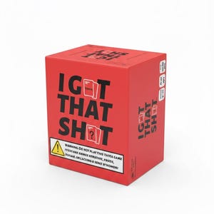 May include: A red trivia game box with the text "I GOT THAT SHOT" in large black letters. The box includes a warning label and the word "TRIVIA". The game box is a cube shape.