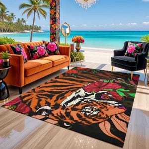 May include: An orange and black tiger-striped rug with a floral design. The rug is placed on a patio with an orange sofa, black chair, and decorative pillows. The background features a beach and ocean view.