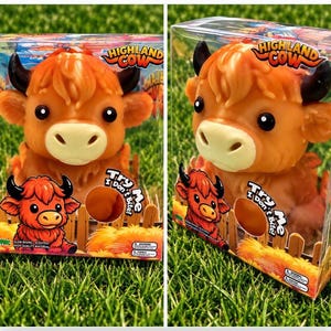 May include: A squishy Highland Cow toy in clear plastic packaging. The orange cow has black horns, large black eyes, and a cream-colored muzzle. The box features the text Highland Cow and Try Me I Don't Bite, along with a cartoon illustration of the cow.