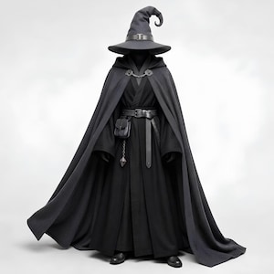 May include: A dark grey pointed hat with a buckle, a long dark grey hooded cloak secured with a metal chain clasp, and a black robe. The outfit includes a black leather belt with a small pouch and a dangling geometric pendant accessory.