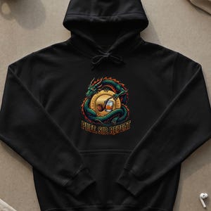 May include: A black hooded sweatshirt featuring a graphic of a green dragon coiled around a gold coin. In the center of the coin is a brown smoking pipe and a glass of amber liquid. The text "PUFF. SIP. REPEAT" is printed in gold below the dragon.