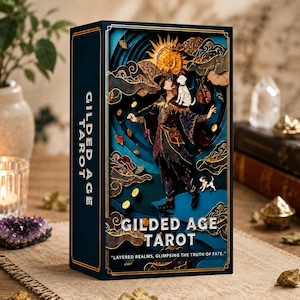 May include: A rectangular Gilded Age Tarot deck box featuring a layered, three-dimensional illustration of a figure with a dog, a sun, and gold coins against a deep blue background. The text reads Gilded Age Tarot and Layered realms, glimpsing the truth of fate.