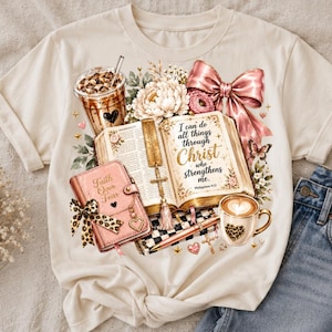 May include: A cream-colored t-shirt featuring a graphic print of an open Bible with the text 'I can do all things through Christ who strengthens me', a pink journal labeled 'Faith Over Fear', a coffee cup, a bow, and floral accents.