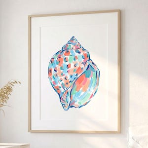 May include: A framed wall art print featuring a stylized seashell illustration. The shell is rendered with vibrant, painterly brushstrokes in shades of coral, turquoise, light blue, and mint green against a clean, solid white background.