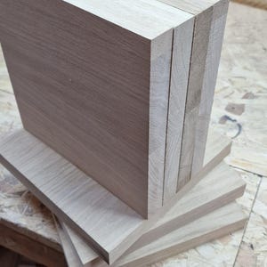 May include: A collection of light brown wooden planks, possibly for carpentry. The planks are stacked, revealing the end and side grain. The wood has a natural, untreated look. The image includes the text "Oscars Dove @woodworking".