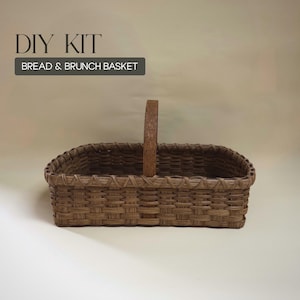 May include: A brown woven basket with a handle, labeled "DIY KIT BREAD & BRUNCH BASKET." The rectangular basket has a woven design and a wooden handle. The basket is designed for carrying items.