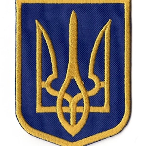 May include: Embroidered patch featuring the Ukrainian coat of arms, a gold trident, on a blue background. The patch has a gold border and is likely for clothing or accessories.