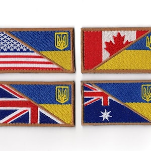 May include: Four embroidered patches featuring the Ukrainian coat of arms combined with the flags of the United States, Canada, the United Kingdom, and Australia. Each patch has a brown border and a diagonal split design.