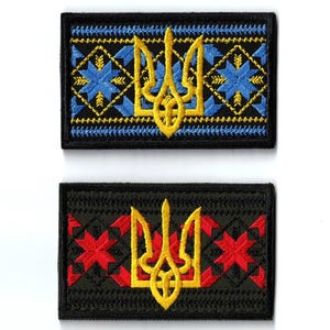 May include: Two embroidered patches featuring the Ukrainian coat of arms, the Tryzub. One patch has a black border with a blue and yellow design. The other patch has a black border with a red and yellow design.