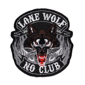 May include: A circular embroidered patch featuring a snarling wolf head with red eyes and bared teeth. The design includes grey flame-like accents and two black banners with white text that reads LONE WOLF on top and NO CLUB on the bottom.
