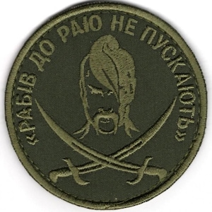 May include: A circular olive green embroidered patch featuring a central design of a Cossack with a traditional hairstyle and mustache, positioned above two crossed sabers. The text "РАБІВ ДО РАЮ НЕ ПУСКАЮТЬ" is stitched in a circular border.