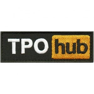 May include: Black rectangular patch with the text "TPO hub". The letters "TPO" are in white, and "hub" is in black on a yellow background. The patch is likely an embroidered emblem.