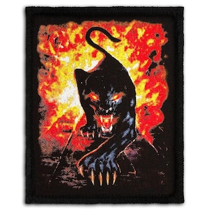 May include: Black panther patch with a fiery background. The panther is black with glowing red eyes and sharp claws. The background is a mix of red, orange, and yellow, resembling flames. The patch has a black border.