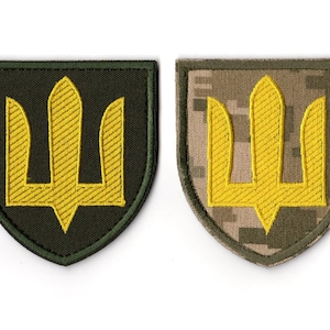 May include: Two embroidered patches featuring the Tryzub, the national emblem of Ukraine. One patch has a yellow Tryzub on a dark green background. The other has a yellow Tryzub on a camouflage background.