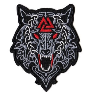 May include: An embroidered patch featuring a stylized wolf head in black, grey, and red thread. The design includes a red Valknut symbol on the forehead, glowing red eyes, and an open mouth with visible white fangs, surrounded by intricate knotwork.