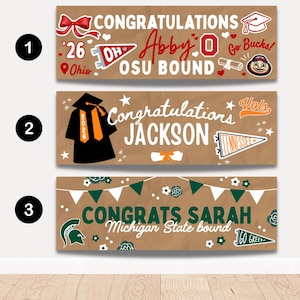 May include: Three graduation banners with brown backgrounds. The top banner says "Congratulations Abby O OSU Bound" with Ohio State University imagery. The middle banner says "Congratulations Jackson" with a graduation cap. The bottom banner says "Congrats Sarah Michigan State bound".