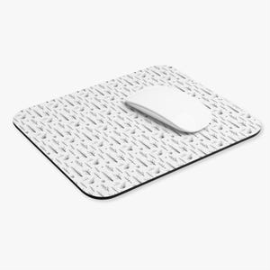 May include: A white computer mouse sits on a rectangular mouse mat. The mat has a black and white pattern of stylized branches and dots. The mat has a black border.