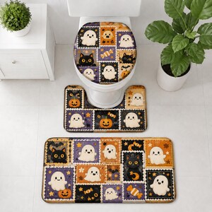 May include: A bathroom set featuring a toilet seat cover and two rectangular floor mats decorated with a repeating pattern of cartoon ghosts, black cats, orange pumpkins, and candy corn on purple, orange, and black square backgrounds.