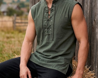 May include: Olive green sleeveless shirt with a lace-up front. The shirt has a mandarin collar and a relaxed fit. The model is wearing black pants. The shirt is made of a lightweight fabric, perfect for warm weather.