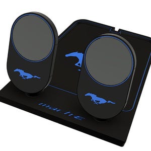 Peut inclure: Un ensemble de pédales noir comprenant deux repose-pieds circulaires avec des contours bleus lumineux et le logo du cheval Mustang en bleu. La plaque de base inclut le texte "mach-e" en bleu et une silhouette de cheval bleue.