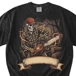 May include: Black t-shirt featuring a skeleton lumberjack wearing a red cap and plaid shirt, operating a chainsaw. The graphic includes lightning bolts and a banner for text. The design is set against a backdrop of trees and logs.