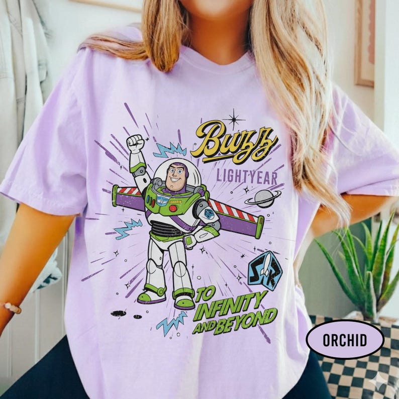 May include: A white ceramic mug with a black handle and the text "But First, Coffee" in a bold, black font. The mug is set against a blurred background, suggesting a cozy setting.