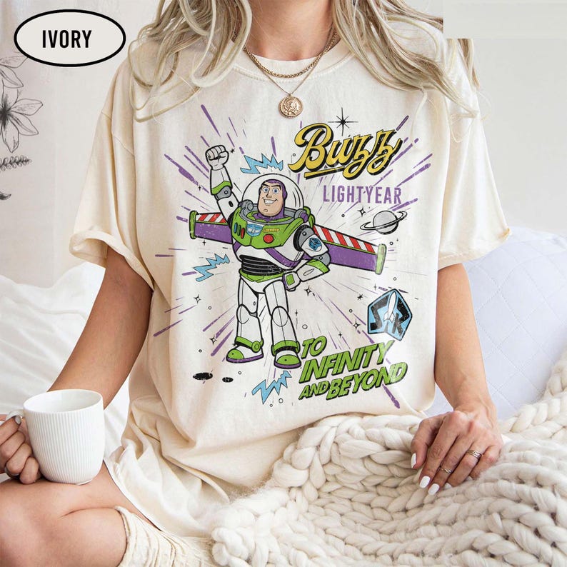 May include: A white ceramic mug with a black handle and the text "But First, Coffee" in a black, handwritten-style font. The mug is on a white surface.