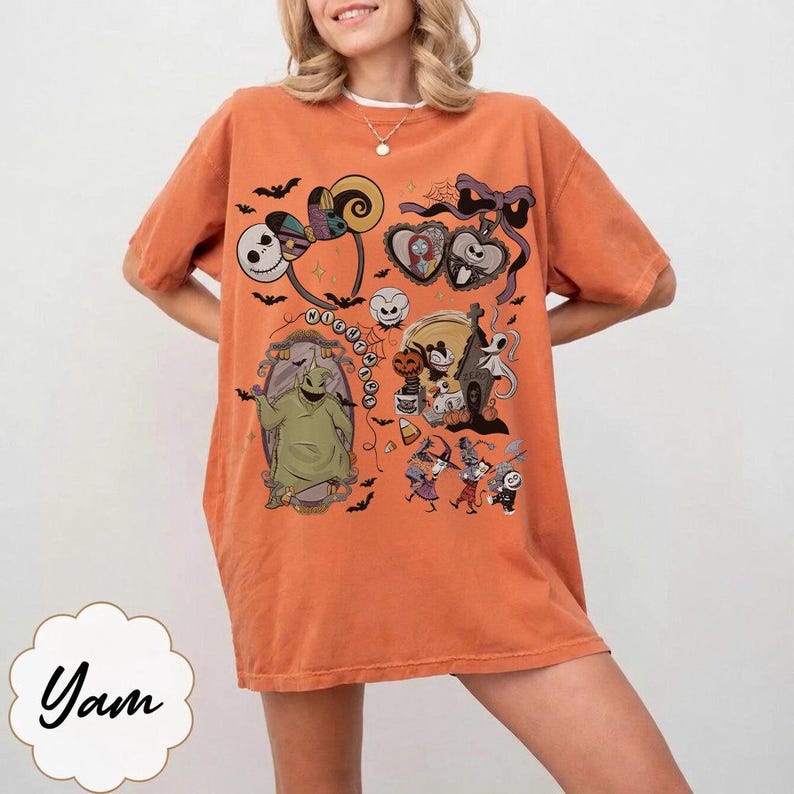 May include: Orange t-shirt featuring a colorful graphic design with characters and elements from "The Nightmare Before Christmas." The design includes Jack Skellington, Sally, Oogie Boogie, and other Halloween-themed imagery. The shirt has short sleeves and a relaxed fit.