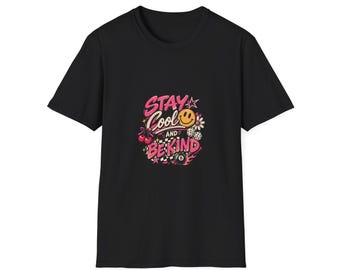 May include: A black short-sleeve t-shirt featuring a graphic print on the chest. The design includes the pink text "STAY COOL AND BE KIND" surrounded by illustrations of a smiley face, cherries, dice, a checkered pattern, and an eight ball.