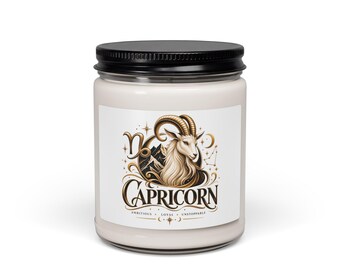 May include: A glass candle jar with a black lid and off-white wax. The label features a gold and black illustration of a Capricorn goat, the Capricorn zodiac symbol, and the text "CAPRICORN AMBITIOUS • LOYAL • UNSTOPPABLE" with star accents.