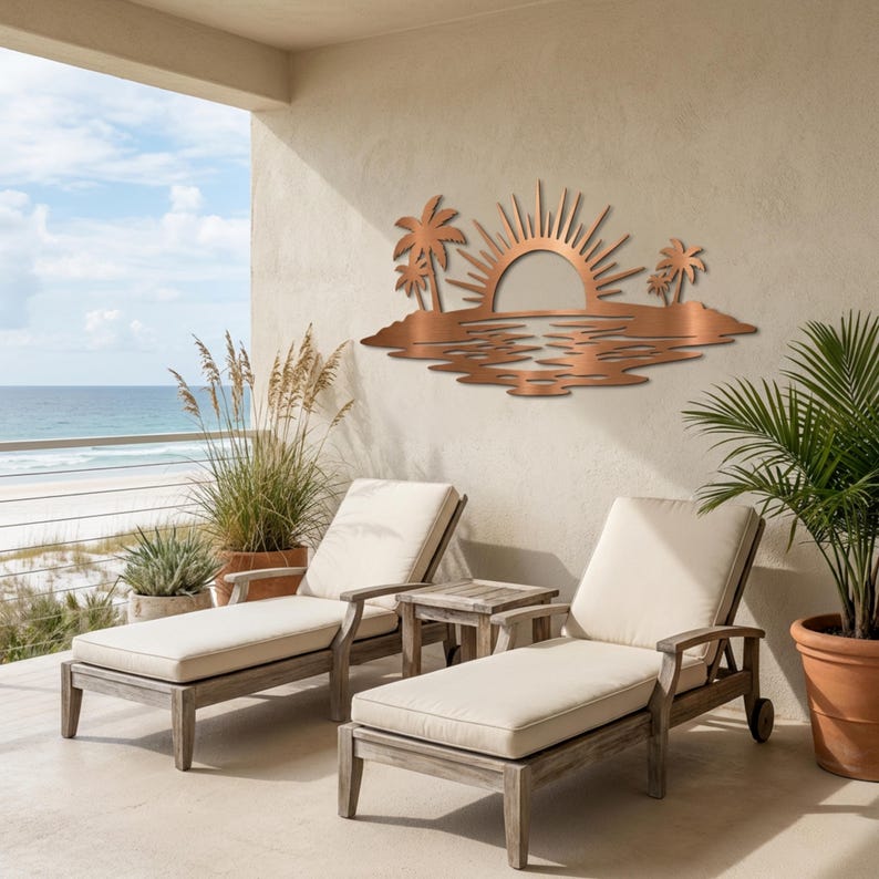 May include: A copper-colored metal wall art piece featuring a stylized sunset over water with palm trees on both sides. The design includes a semi-circular sun with radiating beams, rippling water patterns, and silhouettes of palm trees.