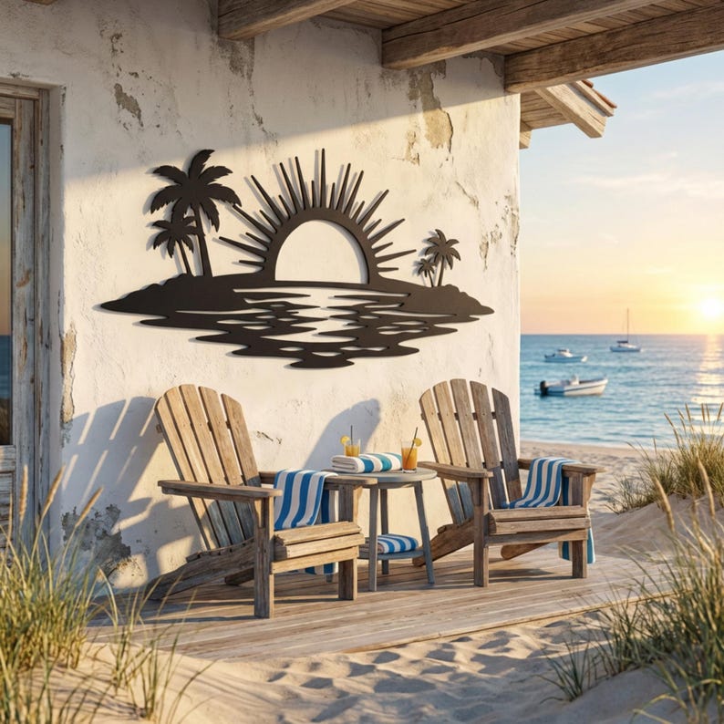 May include: A black metal wall art piece featuring a silhouette of a tropical island with palm trees and a rising sun, mounted on a white wall above two wooden Adirondack chairs and a small side table with drinks on a beachside wooden deck.